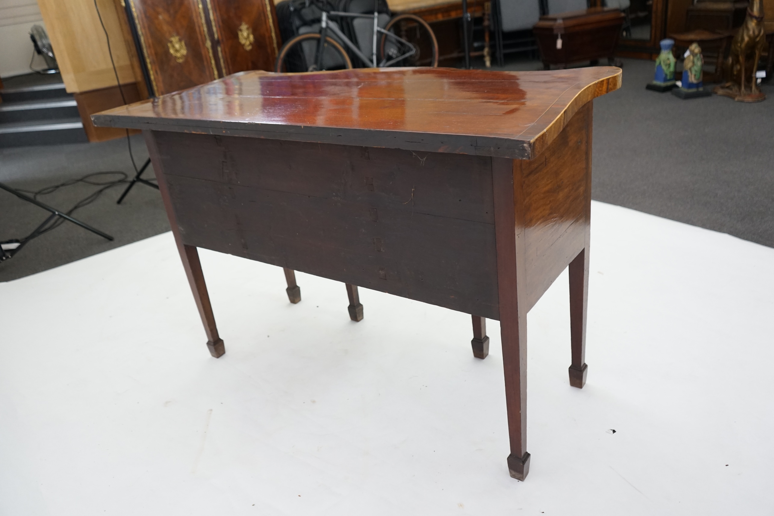 A George III inlaid mahogany serpentine sideboard